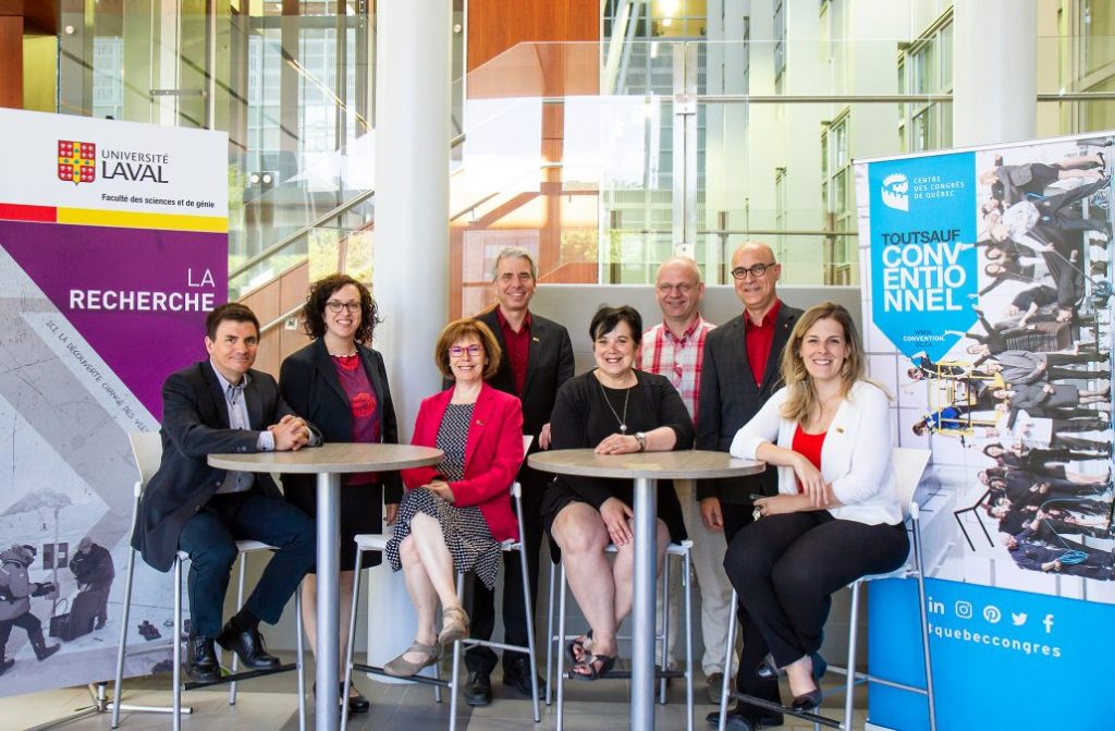 A group of men and women from Université Laval and the Québec City Convention Centre gathered to take a photo.