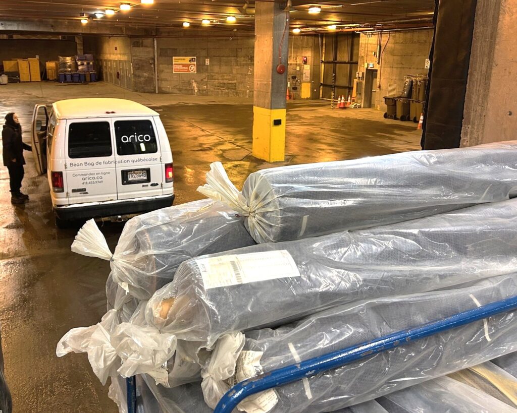 An Arico van parked in the loading area of the Québec City Convention Centre to collect rolls of used textiles (former stage curtains).