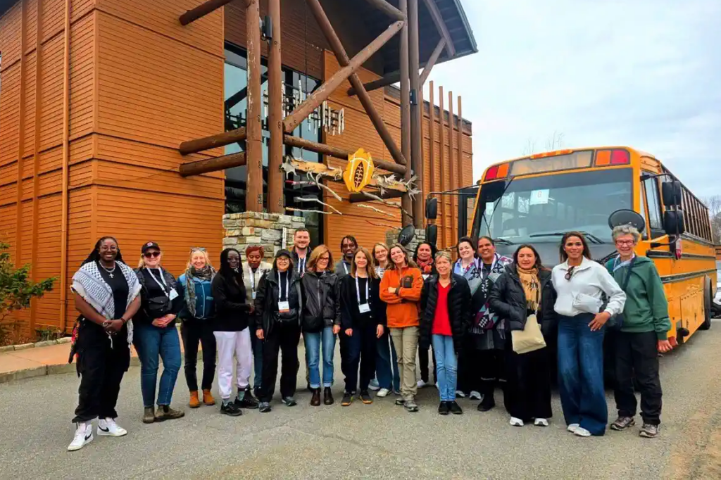 Group of IAIA26 delegates posing for a group photo in front of the Hôtel-Musée Premières Nations in Wendake.