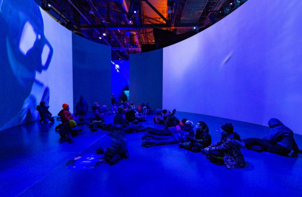 People sitting on floor during Under the Sea exhibiton at the Québec City Convention Centre.