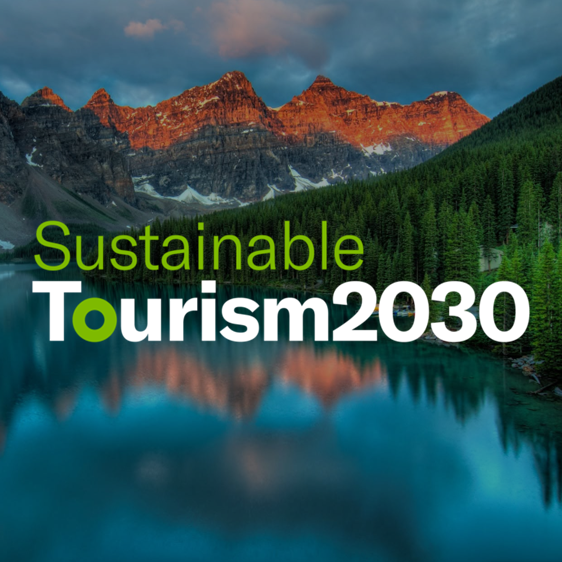 Logo du Sustainable Tourism 2030, dans des teintes de vert, avec une montagne et un lac en arrière-plan