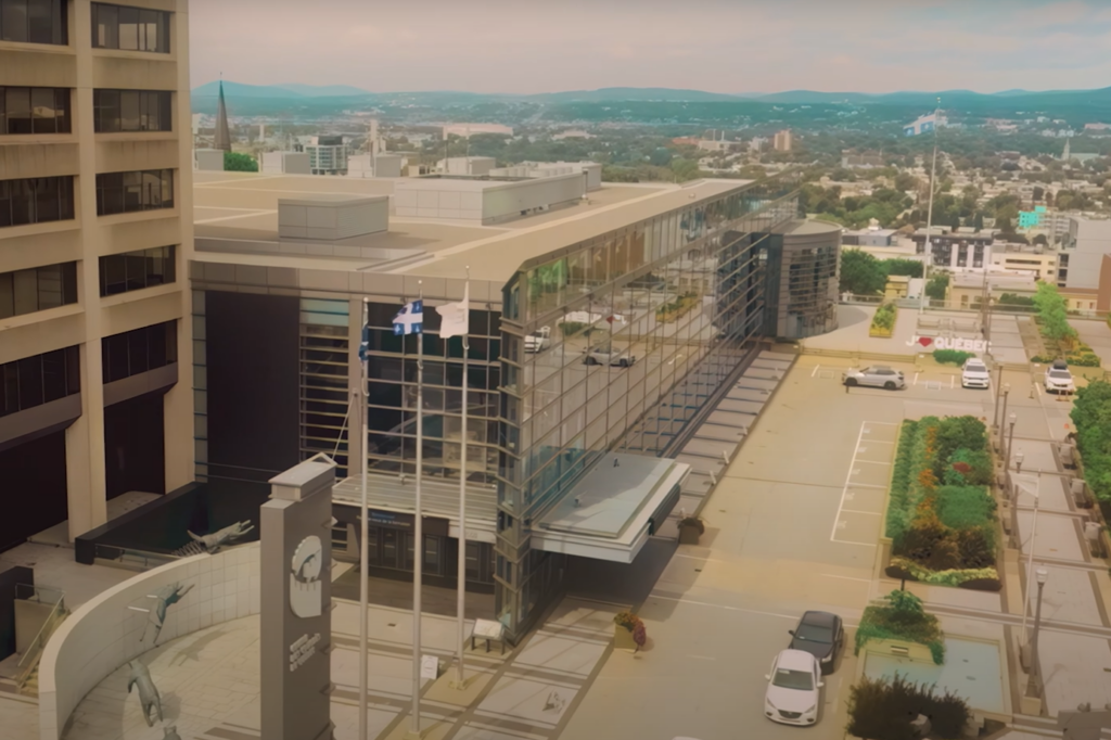 Thumbnail from the promotional video “Anything but Conventional,” showing an aerial view of the Québec City Convention Centre façade.
