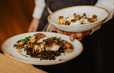 2 belles assiettes d'un repas de morue avec ses garnitures, du restaurant Chez Boulay.